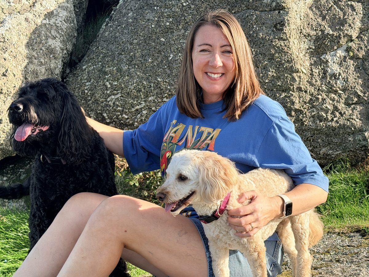 Sarah Rees of Guiding Therapy, smiling, with her dog